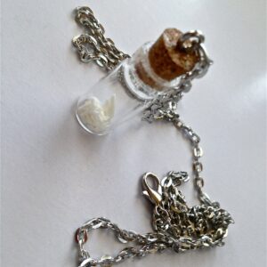 Glass vial of teeth necklace